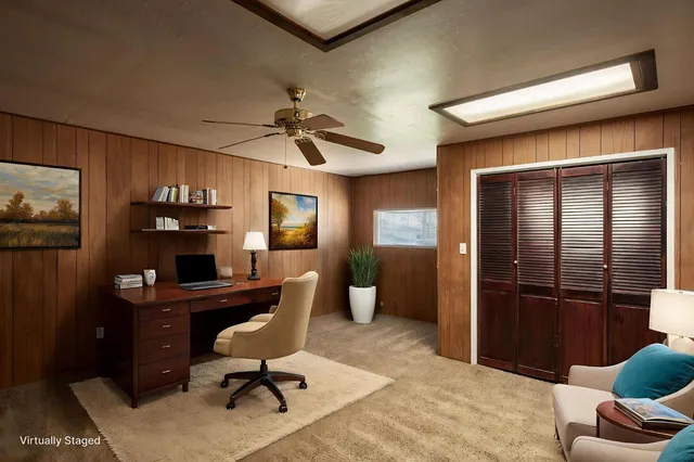 an empty room with a window and a fan