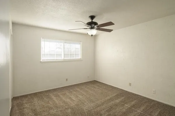 a view of a house with a yard and tree