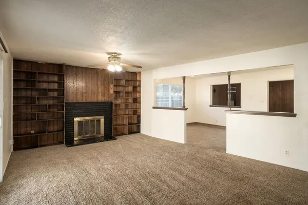 a view of a kitchen with a sink and refrigerator