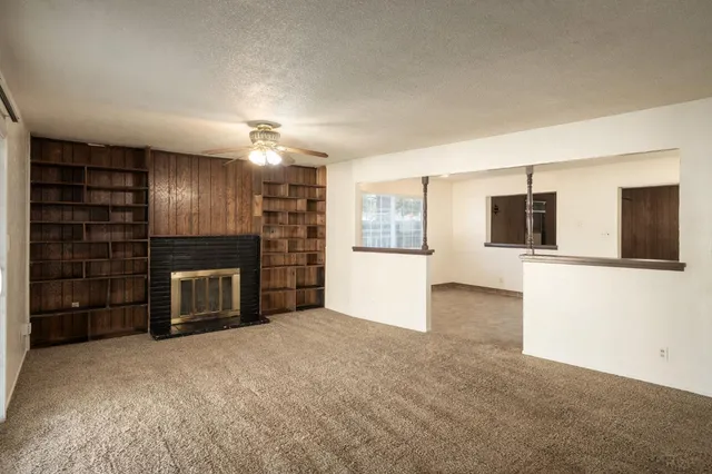 a view of a kitchen with a sink and refrigerator