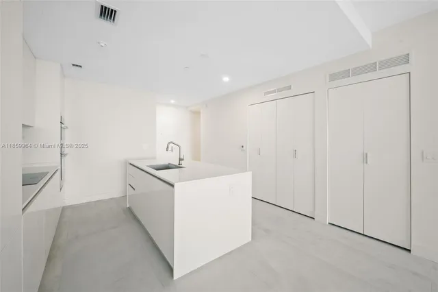 a kitchen with a sink cabinets and a stove