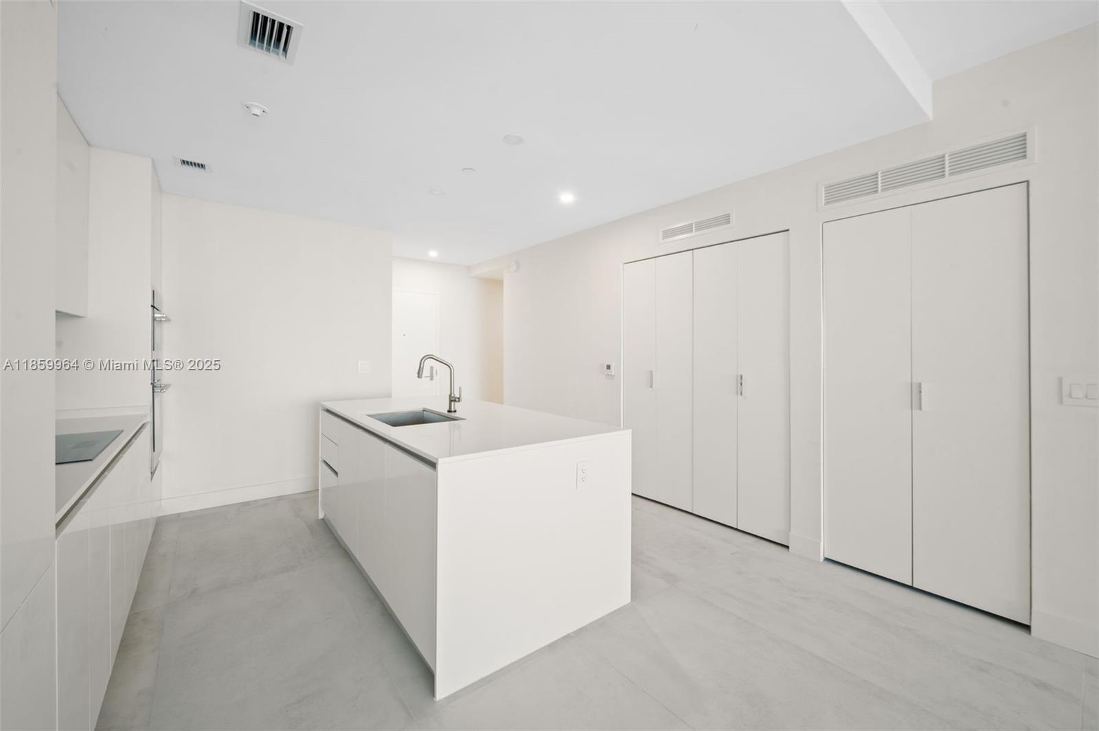 700 Northeast 24th Street, Unit 1406 Miami, FL 33137 - Photo 11 of 55 a utility room with cabinets washer and dryer