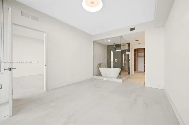 a bathroom with a bathtub and shower