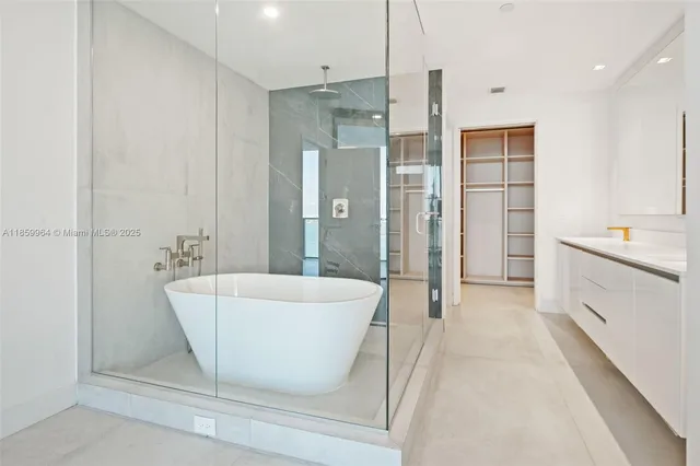 a spacious bathroom with a shower sink and mirror