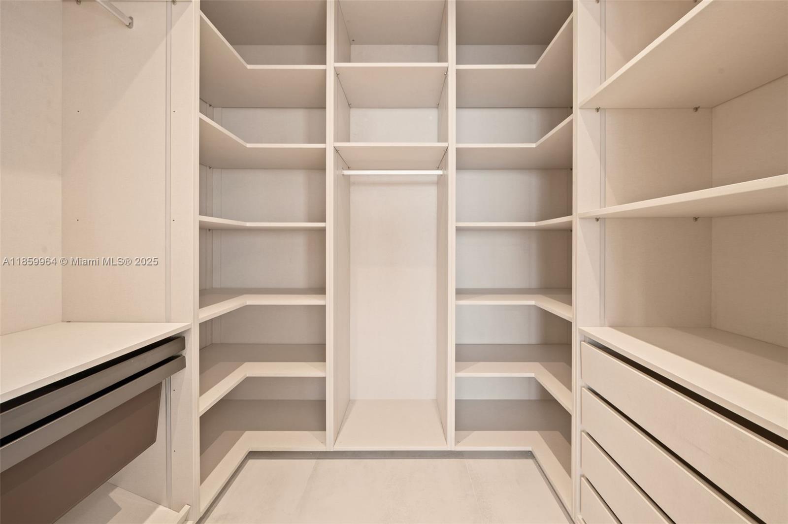 700 Northeast 24th Street, Unit 1406 Miami, FL 33137 - Photo 18 of 55 a view of walk in closet with empty racks