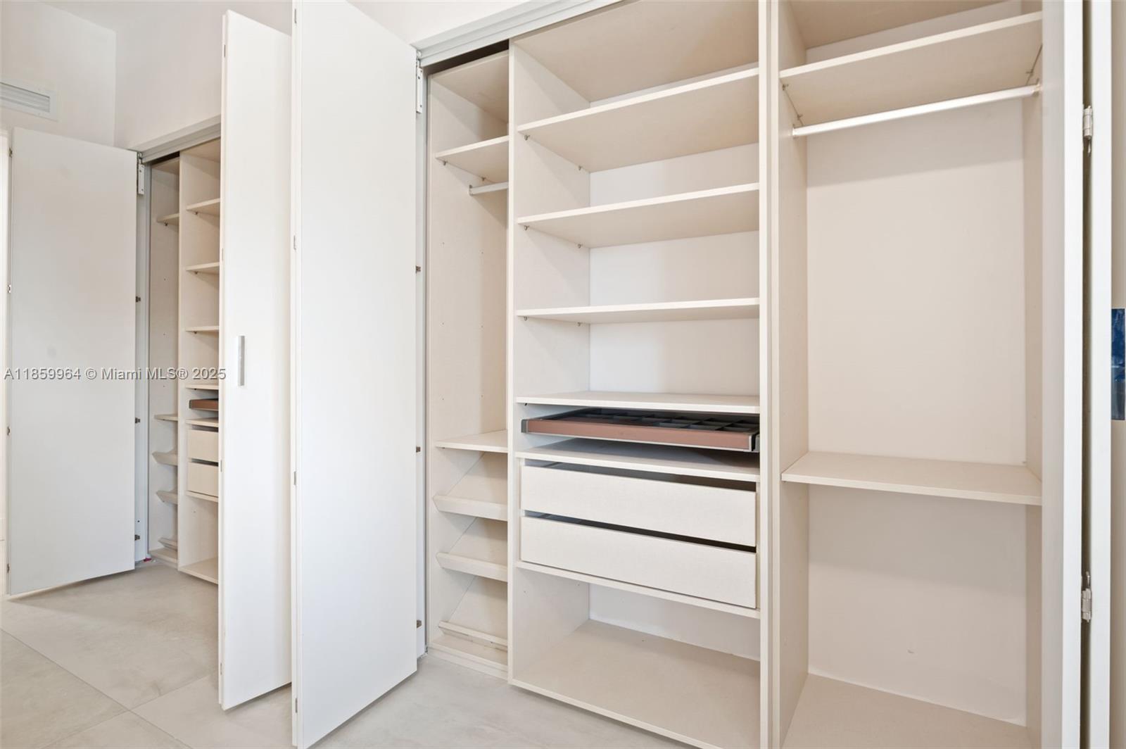 700 Northeast 24th Street, Unit 1406 Miami, FL 33137 - Photo 24 of 55 a view of walk in closet with empty racks