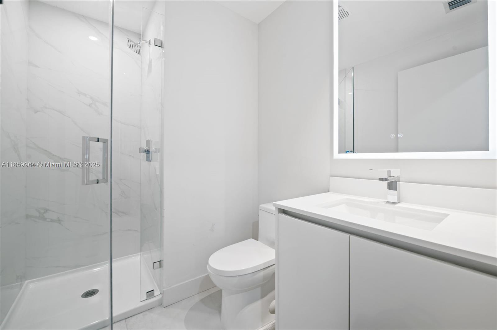 700 Northeast 24th Street, Unit 1406 Miami, FL 33137 - Photo 25 of 55 a bathroom with a sink a toilet and shower