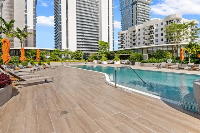 a view of a tall building next to a yard