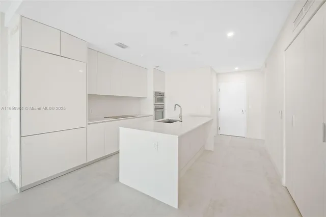 a utility room with cabinets washer and dryer