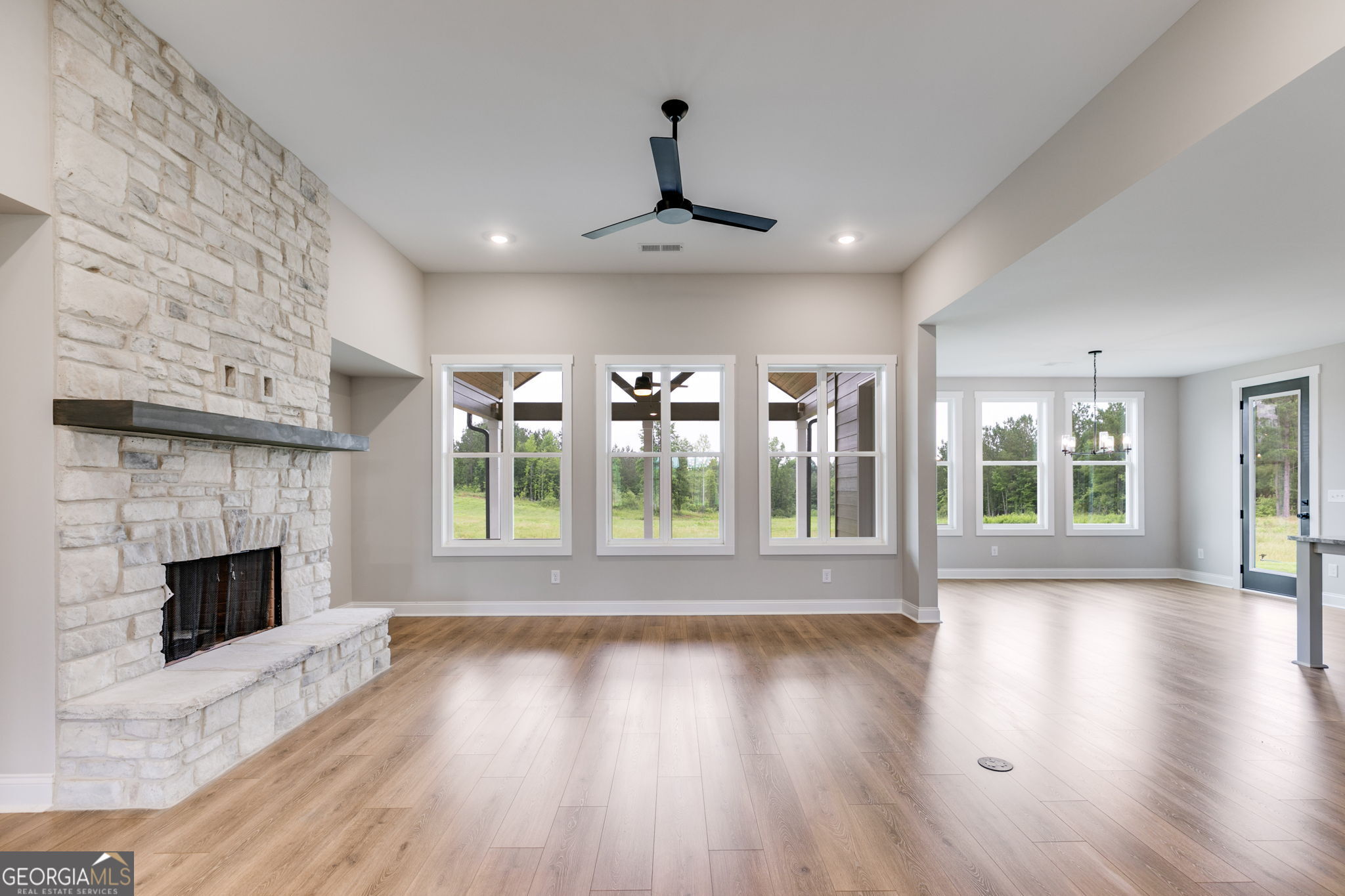1611 Bethesda Church Road Carrollton, GA 30117 - Photo 6 of 45 a view of an empty room with wooden floor fireplace and a window
