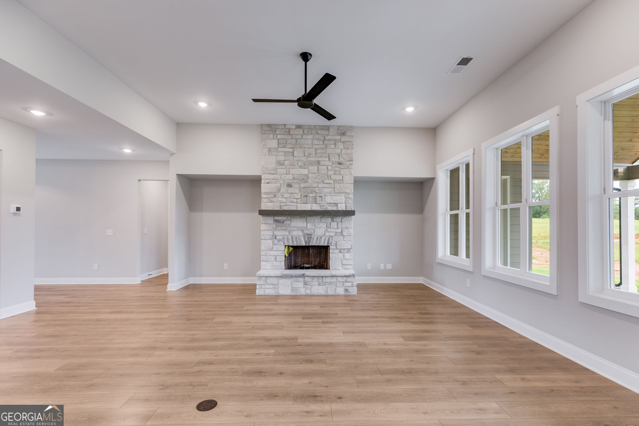 1611 Bethesda Church Road Carrollton, GA 30117 - Photo 7 of 45 a view of a livingroom with a fireplace wooden floor and window