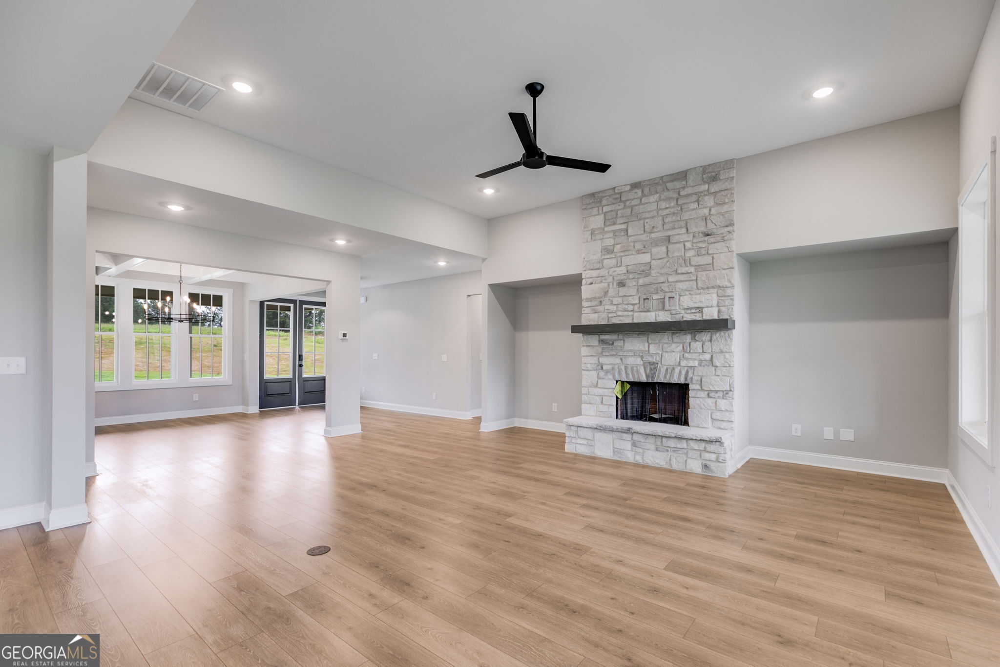 1611 Bethesda Church Road Carrollton, GA 30117 - Photo 8 of 45 a view of an empty room with wooden floor fireplace and a window