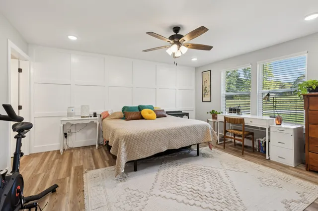 a bedroom with a bed and wooden floor