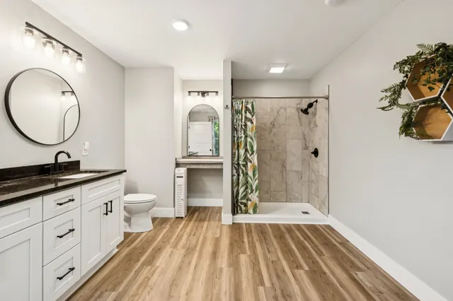 a bathroom with a sink a toilet and a mirror