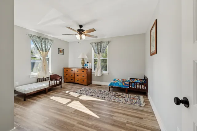 a living room with furniture and a baby crib