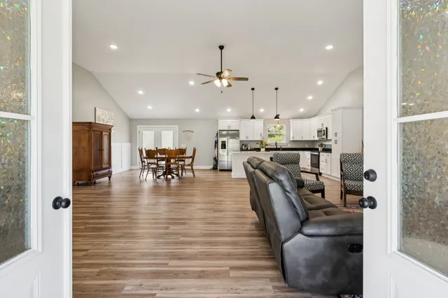 a view of a dining hall with furniture and wooden floor