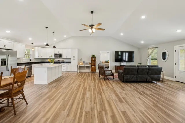 a large kitchen with cabinets a sink and a stove