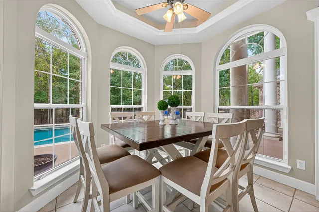 a view of a dining room with furniture a chandelier and wooden floor