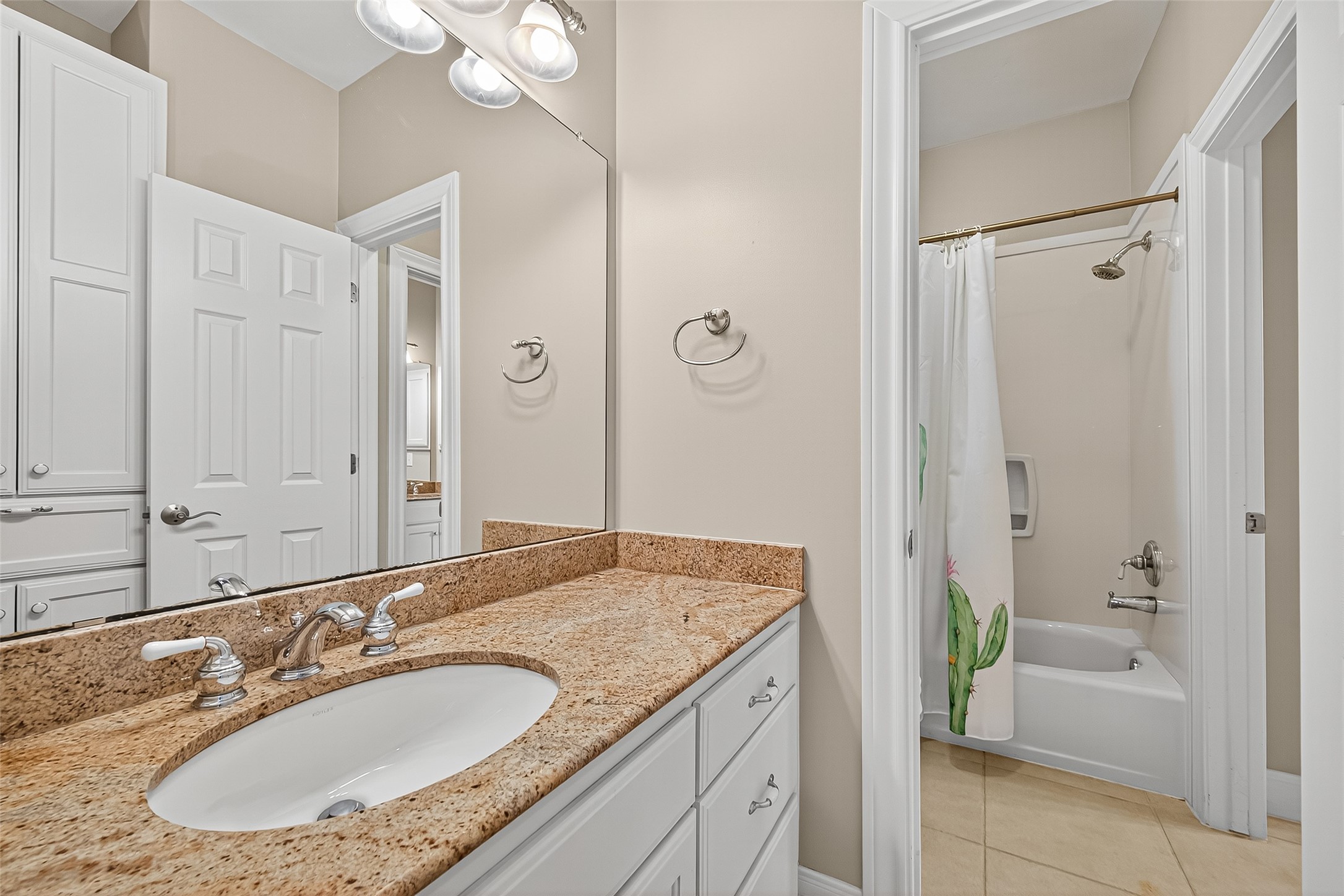 32819 Whitburn Trail Fulshear, TX 77441 - Photo 30 of 49 a bathroom with a granite countertop sink a mirror a vanity and a bathtub