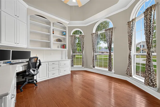 a view of workspace with wooden floor and windows