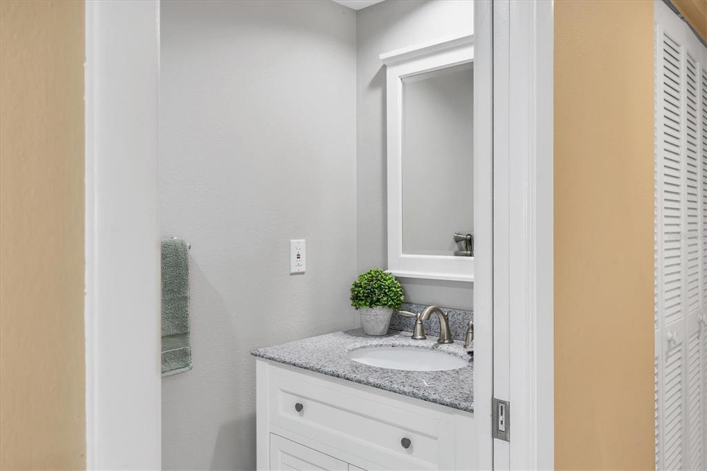 540 Beach Road, Unit 510 Sarasota, FL 34242 - Photo 18 of 96 a bathroom with a granite countertop sink and a mirror