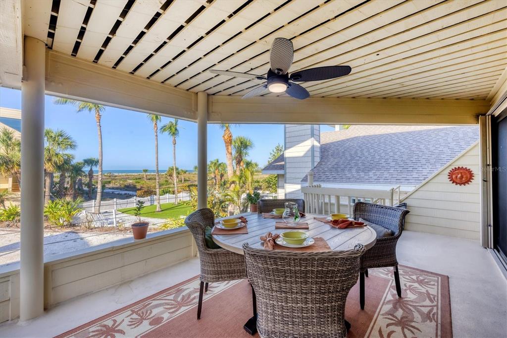 540 Beach Road, Unit 510 Sarasota, FL 34242 - Photo 29 of 96 a view of an outdoor dining space with a table and chairs
