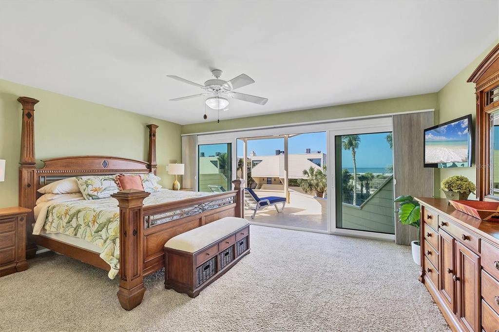 540 Beach Road, Unit 510 Sarasota, FL 34242 - Photo 32 of 96 a bedroom with a large bed and a chandelier
