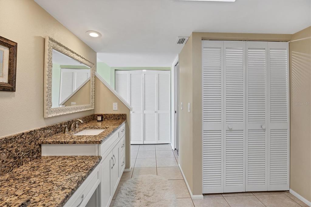 540 Beach Road, Unit 510 Sarasota, FL 34242 - Photo 43 of 96 a bathroom with a granite countertop sink and a mirror