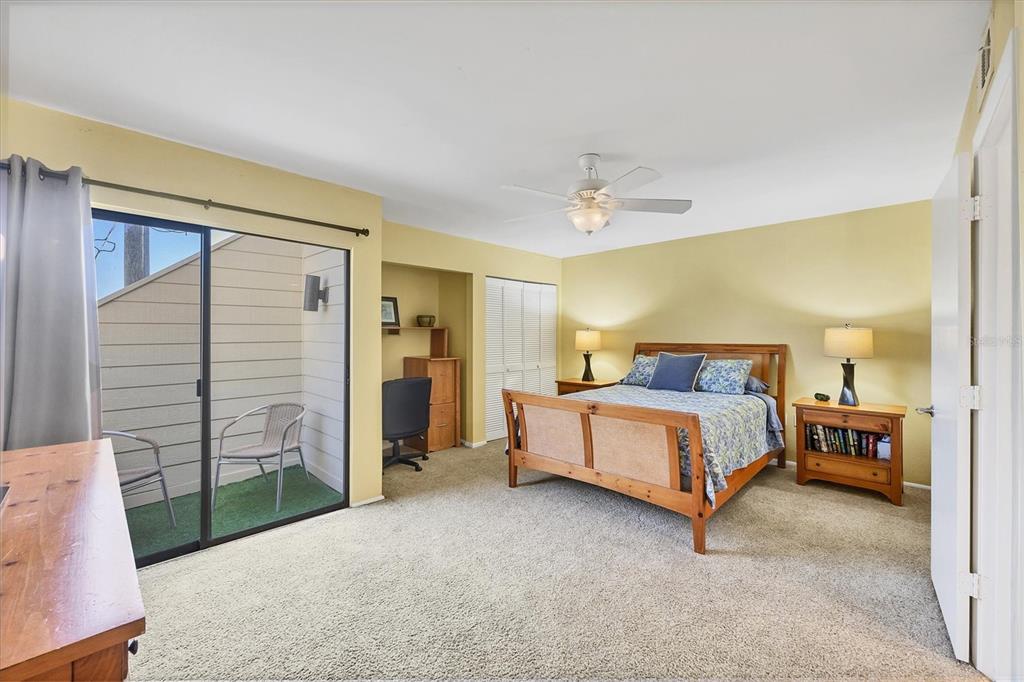 540 Beach Road, Unit 510 Sarasota, FL 34242 - Photo 47 of 96 a spacious bedroom with a bed and a lamp