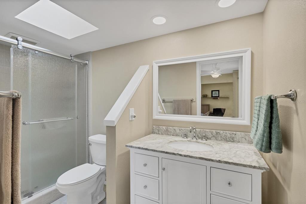 540 Beach Road, Unit 510 Sarasota, FL 34242 - Photo 49 of 96 a bathroom with a granite countertop sink toilet and shower