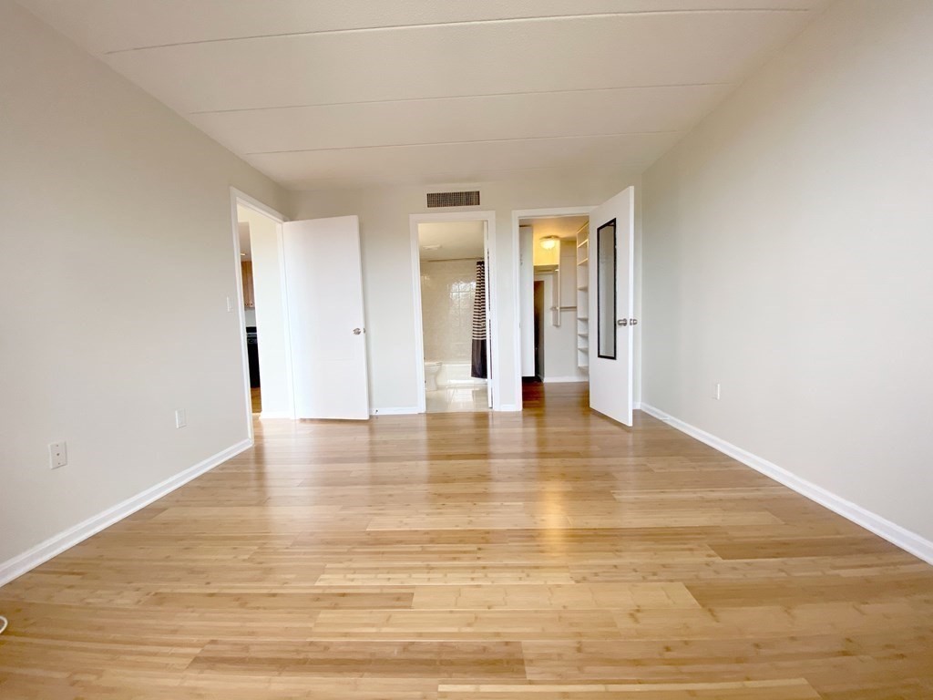 85 Brainerd Road, Unit 503 Boston, MA 02134 - Photo 7 of 21 a view of an empty room with wooden floor and closet