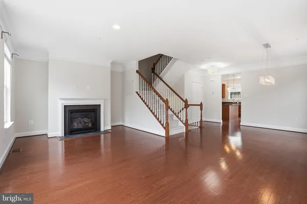 a view of a hallway with wooden floor and a fireplace