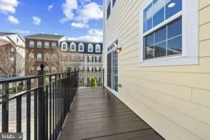 a view of a balcony with wooden floor and fence