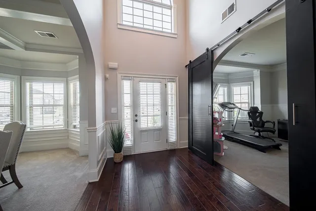 a view of a livingroom with furniture hardwood floor and a large window