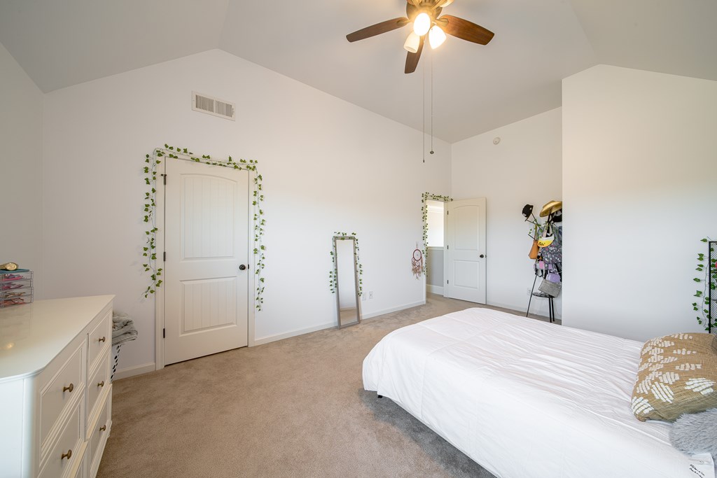 33 Utah Street Fort Mitchell, AL 36856 - Photo 25 of 49 a bedroom with a bed and a chandelier