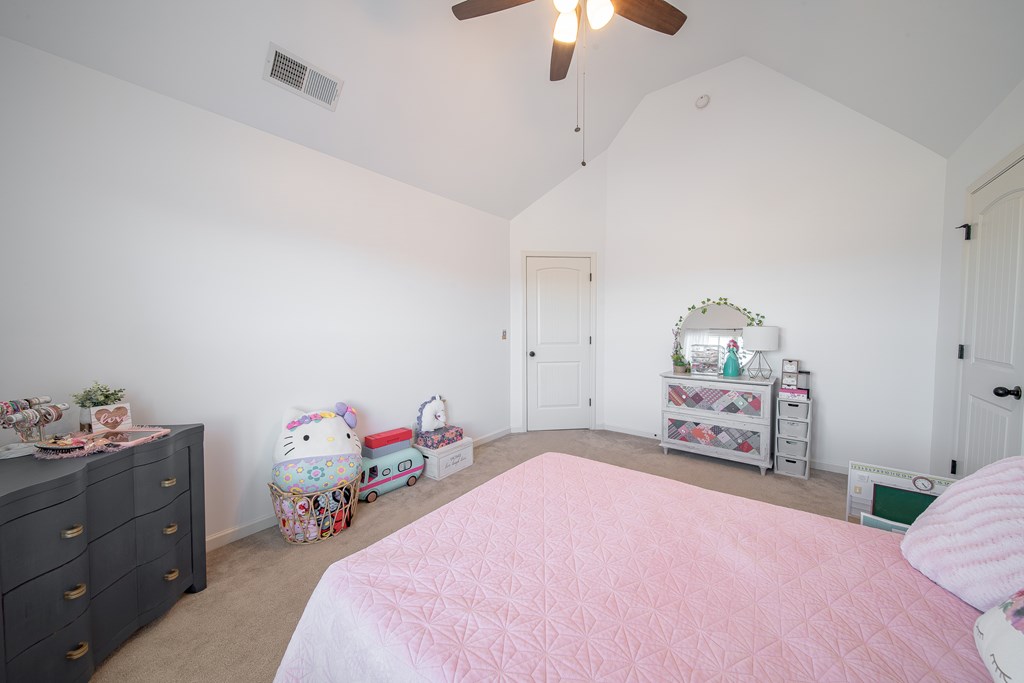 33 Utah Street Fort Mitchell, AL 36856 - Photo 28 of 49 a bedroom with a bed and a chandelier