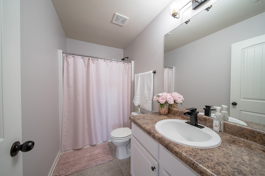 33 Utah Street Fort Mitchell, AL 36856 - Photo 29 of 49 a bathroom with a granite countertop sink and a mirror with toilet
