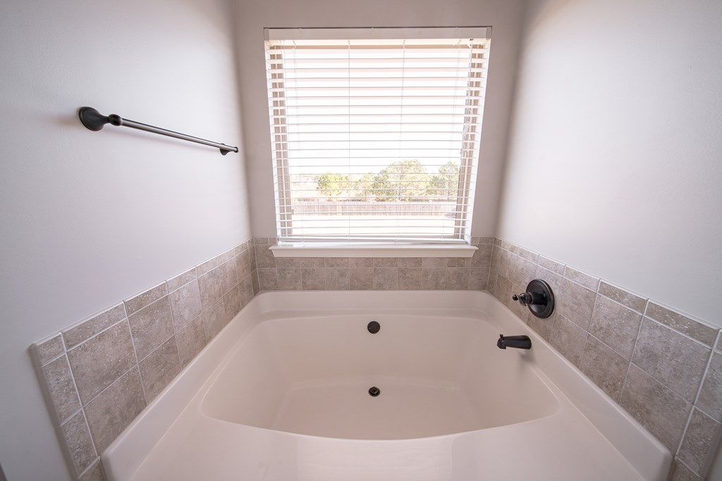33 Utah Street Fort Mitchell, AL 36856 - Photo 35 of 49 a bathroom with a tub and a window