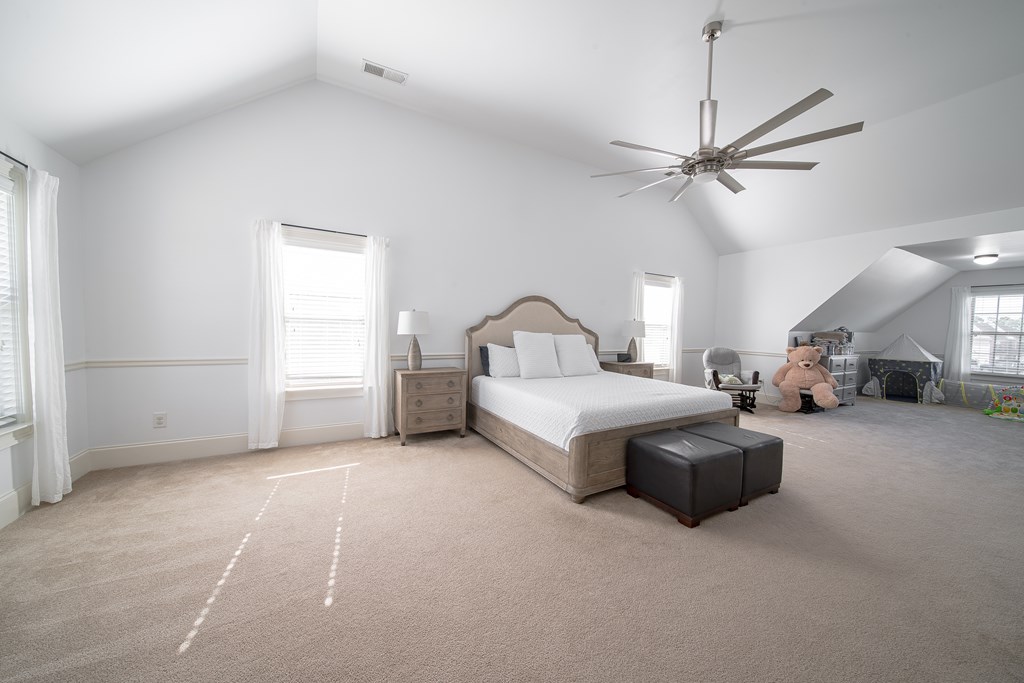 33 Utah Street Fort Mitchell, AL 36856 - Photo 39 of 49 a spacious bedroom with a bed and a chandelier