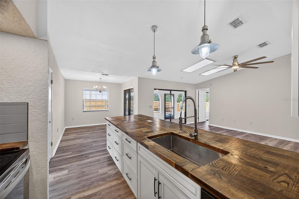 12435 Lola Drive Spring Hill, FL 34608 - Photo 16 of 63 a kitchen with granite countertop a sink a counter top space and cabinets