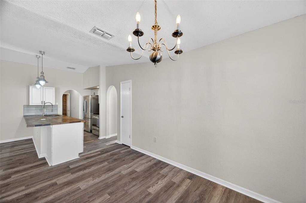 12435 Lola Drive Spring Hill, FL 34608 - Photo 19 of 63 a view of kitchen and hall with wooden floor