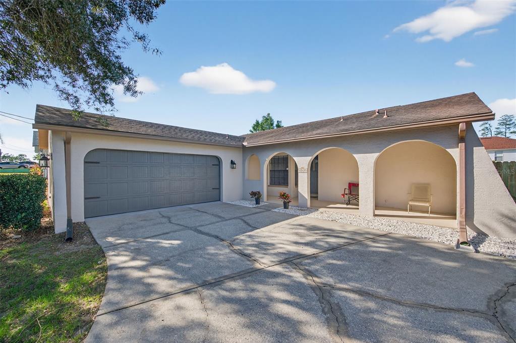 12435 Lola Drive Spring Hill, FL 34608 - Photo 2 of 63 a front view of a house with a yard and garage