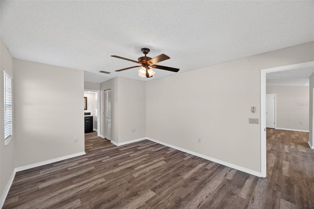 12435 Lola Drive Spring Hill, FL 34608 - Photo 22 of 63 a view of empty room with wooden floor