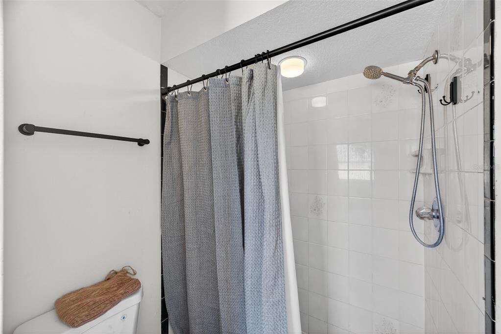 12435 Lola Drive Spring Hill, FL 34608 - Photo 27 of 63 a bathroom with a shower and a shower curtain