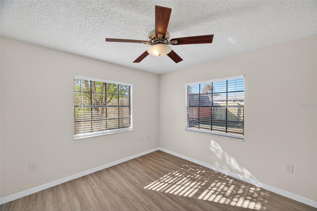 12435 Lola Drive Spring Hill, FL 34608 - Photo 28 of 63 a view of an empty room with a window and wooden floor