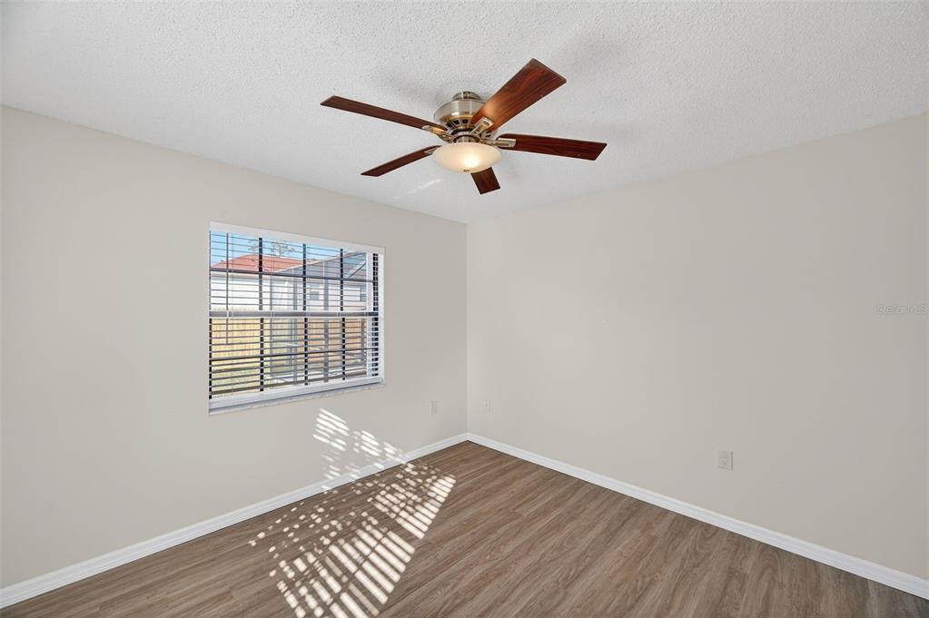 12435 Lola Drive Spring Hill, FL 34608 - Photo 29 of 63 a view of a room with a ceiling fan and wooden floor