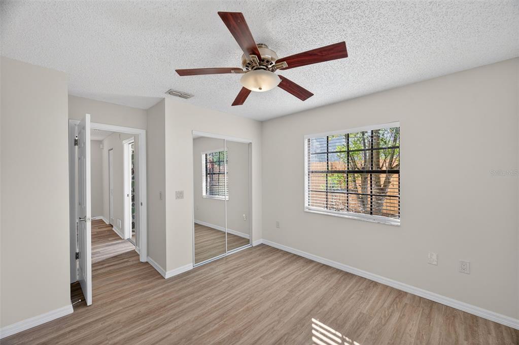12435 Lola Drive Spring Hill, FL 34608 - Photo 30 of 63 a view of empty room with wooden floor and fan