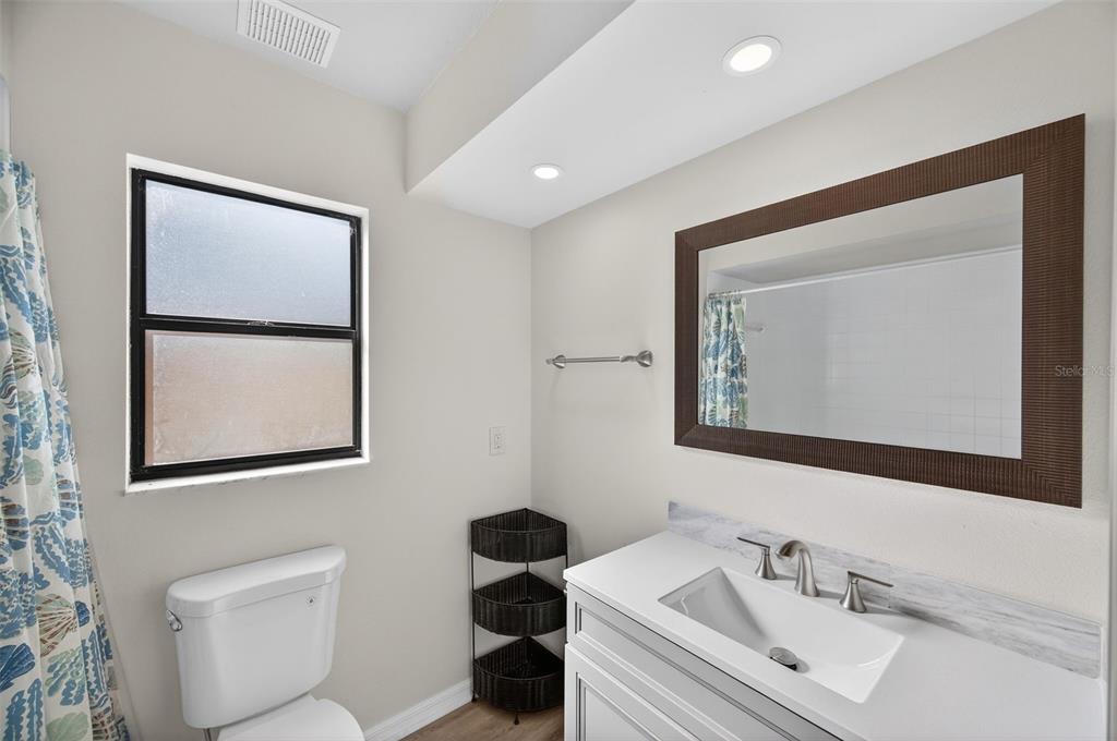 12435 Lola Drive Spring Hill, FL 34608 - Photo 32 of 63 a bathroom with a toilet sink and mirror