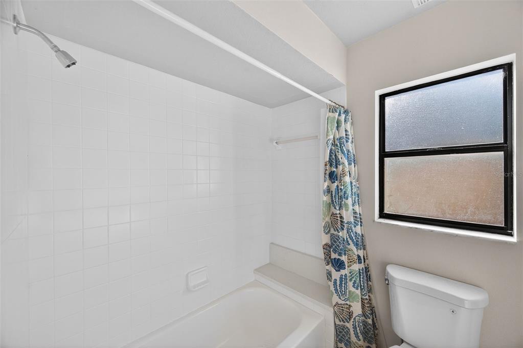 12435 Lola Drive Spring Hill, FL 34608 - Photo 33 of 63 a bathroom with a shower a toilet and sink