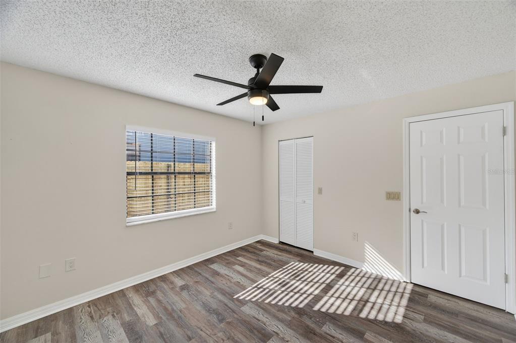 12435 Lola Drive Spring Hill, FL 34608 - Photo 37 of 63 a view of an empty room with a window and a kitchen